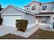 Two-story house with a double garage and well-manicured landscaping at 1347 Heather Lake Dr, Orlando, FL 32824