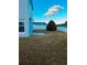 Home's backyard with canal view, green grass, and fence at 1347 Heather Lake Dr, Orlando, FL 32824