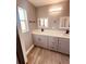 Modern bathroom with double vanity and gray cabinets at 1347 Heather Lake Dr, Orlando, FL 32824