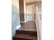 Upstairs hallway with wood-look flooring and white trim at 1347 Heather Lake Dr, Orlando, FL 32824