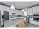 Modern kitchen with a large island, stainless steel appliances, and granite countertops at 3086 Norcott Dr, Davenport, FL 33837