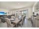 Bright dining room with a large wooden table and access to backyard at 7876 Oak Reflection Loop, Davenport, FL 33837