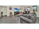 Spacious living room featuring gray sofas, a fireplace, and large-screen TV at 7876 Oak Reflection Loop, Davenport, FL 33837