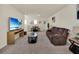 Open bonus room offering a relaxing seating area and a separate dining space at 7876 Oak Reflection Loop, Davenport, FL 33837