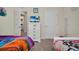 Bedroom with twin and full-size beds, dresser and view into bathroom at 7876 Oak Reflection Loop, Davenport, FL 33837