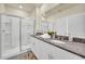 Modern bathroom with double vanity, granite countertop, and a walk-in shower at 7876 Oak Reflection Loop, Davenport, FL 33837