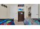 ' bedroom with twin beds and a dresser, plus a view into another room at 7876 Oak Reflection Loop, Davenport, FL 33837