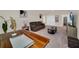 Open loft area with a brown couch and a wooden table at 7876 Oak Reflection Loop, Davenport, FL 33837