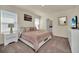Main bedroom with king-size bed, en-suite bathroom, and plenty of natural light at 7876 Oak Reflection Loop, Davenport, FL 33837