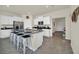 Modern kitchen with white cabinets, granite island and breakfast bar at 7876 Oak Reflection Loop, Davenport, FL 33837