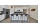 Modern kitchen with white cabinets and granite countertops at 7876 Oak Reflection Loop, Davenport, FL 33837