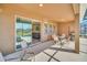 Covered patio with seating area, grill, and view of the pool at 7876 Oak Reflection Loop, Davenport, FL 33837
