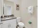Clean bathroom with granite countertop, white cabinets, and a toilet at 7876 Oak Reflection Loop, Davenport, FL 33837