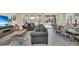 Open living room with gray sofas, fireplace, and large TV, leading to dining area at 7876 Oak Reflection Loop, Davenport, FL 33837