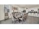Elegant dining room featuring a large table and chairs, adjacent to kitchen at 7876 Oak Reflection Loop, Davenport, FL 33837