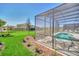 Landscaped backyard with pool and screened enclosure at 7876 Oak Reflection Loop, Davenport, FL 33837