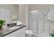 Stylish bathroom with granite countertop, white cabinets, and shower at 7876 Oak Reflection Loop, Davenport, FL 33837