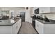 Modern kitchen with white cabinets and granite countertops at 7876 Oak Reflection Loop, Davenport, FL 33837