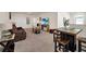 Spacious loft area with a brown couch and a wooden table at 7876 Oak Reflection Loop, Davenport, FL 33837