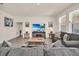 Bright living room with comfy sofas, a large TV, and a fireplace at 7876 Oak Reflection Loop, Davenport, FL 33837