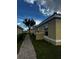 Tan building exterior with a walkway and landscaping at 1650 Cumin Dr, Kissimmee, FL 34759