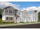 Modern 2-story townhome with gray siding and stone accents at 15859 Tollington Aly, Winter Garden, FL 34787