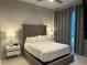 Bright bedroom with a king-size bed, nightstands, and gray curtains at 7740 Sandy Ridge Dr # 135, Kissimmee, FL 34747