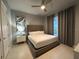 King-size bed, nightstand, and large window at 7740 Sandy Ridge Dr # 135, Kissimmee, FL 34747