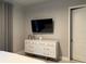 White dresser with a TV and gray curtains at 7740 Sandy Ridge Dr # 135, Kissimmee, FL 34747