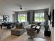 Spacious living room with sectional sofa and large windows at 7740 Sandy Ridge Dr # 135, Kissimmee, FL 34747