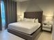 Elegant bedroom with a king-size bed, nightstands, and gray curtains at 7740 Sandy Ridge Dr # 135, Kissimmee, FL 34747