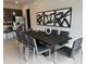 Modern dining area with large table and gray chairs at 7740 Sandy Ridge Dr # 135, Kissimmee, FL 34747