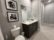 Modern bathroom with dark vanity and a large mirror at 7740 Sandy Ridge Dr # 135, Kissimmee, FL 34747