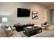 Bright living room featuring comfortable seating and a large TV at 7740 Sandy Ridge Dr # 135, Kissimmee, FL 34747