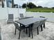 Relaxing patio with dining table and lounge chairs at 7740 Sandy Ridge Dr # 135, Kissimmee, FL 34747