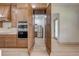 Kitchen pantry with wood cabinets and additional refrigerator at 4266 La Salle Ave, Saint Cloud, FL 34772