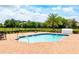 Community pool with brick patio and lounge chairs at 2112 Broome St, Kissimmee, FL 34743