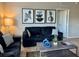 Living room featuring a sofa set, coffee table, and wall art at 4814 Cayview Ave # 21013, Orlando, FL 32819