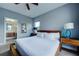 Bedroom with queen bed, en-suite bathroom, and private balcony access at 1561 Corolla Ct, Reunion, FL 34747