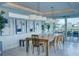Elegant dining room with a rustic wooden table and modern lighting at 1561 Corolla Ct, Reunion, FL 34747