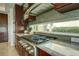 Modern kitchen with gas cooktop, granite countertops, and stainless steel appliances at 1561 Corolla Ct, Reunion, FL 34747