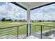 Balcony overlooking a lush golf course with houses in the background at 1561 Corolla Ct, Reunion, FL 34747