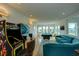 Game room with pool table, arcade game, and comfortable seating at 1561 Corolla Ct, Reunion, FL 34747