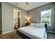 Bright bedroom with ensuite bathroom and comfortable bed at 1561 Corolla Ct, Reunion, FL 34747