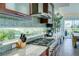 Modern kitchen boasts granite countertops, stainless steel appliances, and a sleek backsplash at 1561 Corolla Ct, Reunion, FL 34747