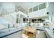 Two-story living room with open floor plan and modern staircase at 1561 Corolla Ct, Reunion, FL 34747