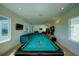 Game room with a pool table and comfortable seating area at 1561 Corolla Ct, Reunion, FL 34747