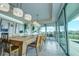 Elegant dining area with large farmhouse table and modern lighting at 1561 Corolla Ct, Reunion, FL 34747