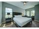 Spacious bedroom with a king-size bed and sitting area at 1561 Corolla Ct, Reunion, FL 34747