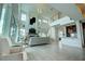 Open concept living area with high ceilings and a modern fireplace at 1561 Corolla Ct, Reunion, FL 34747